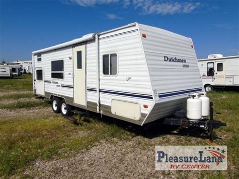 It is a very clean lite weight trailer with a rear corner bed, bathroom with shower, full size RV refrigerator, front sofabed, captains chair and more. . 2004 dutchmen sport lite 28ft